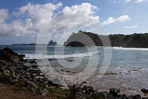 Meio beach in Brazil with a rocky shore on a bright sunny day photo