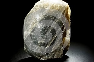 Meionite Quartz fossil mineral stone. Geological crystalline fossil. Dark background close-up.