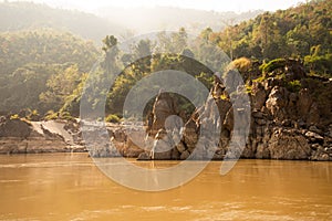 The Mekong river in Laos. River shore and tropical jungle.