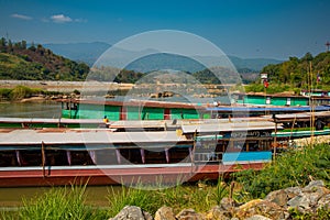 Mekong river, Laos and Thailand at Huay Xai. Traditional wooden boats