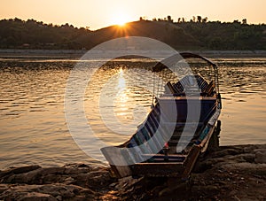 Mekong river, Laos and Thailand at Huay Xai. Traditional wooden boats at sunset