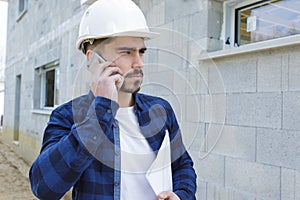 mel builder on phone outdoors