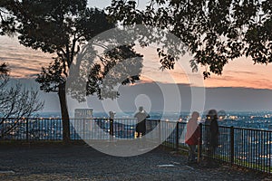 People and state of mind: melancholic atmosphere with blurred people enjoying Brescia & x27;s skyline at sunset photo