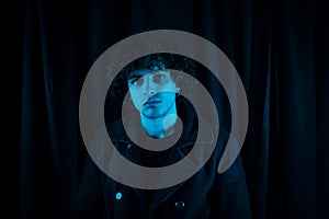 Melancholic guy on dark background