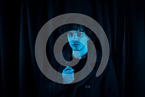 Melancholic guy on dark background