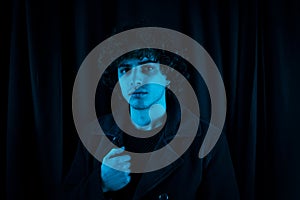 Melancholic guy on dark background