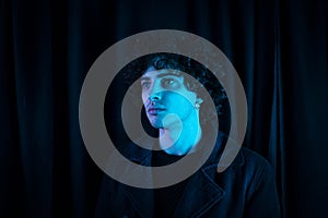 Melancholic guy on dark background