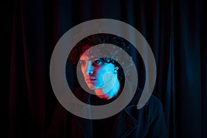 Melancholic guy on dark background