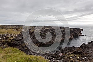 Melancholic Iceland landscape with dark cliff.