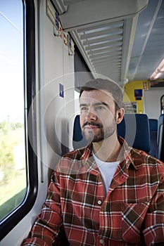 Melancholic man traveling by train