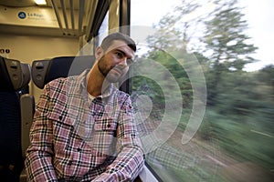 Melancholic man traveling by train