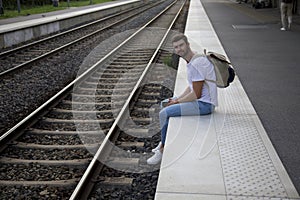 Melancholic man waiting for a train