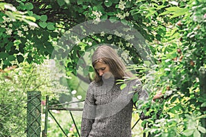 Melancholic pensive young woman in the countryside against the background of nature