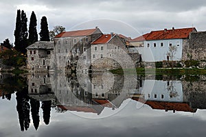 Melancholic scene with Houses reflected on river in Bosnia and Herzegovina