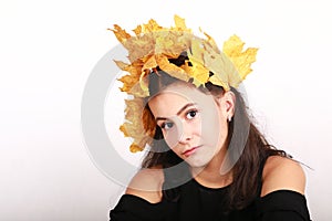 Melancholic teen girl with maple leaves in hair