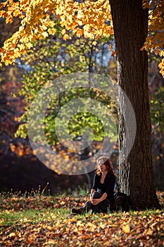 Melancholic woman rests under a tree