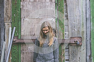 Melancholic woman standing by the closed door