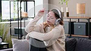 Melancholy Woman Listening Music On Sofa At Home
