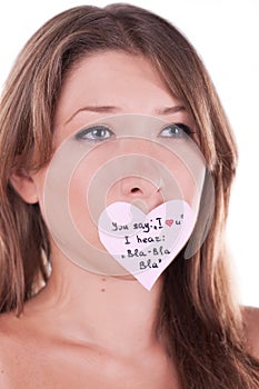 Melancholy young woman with paper heart sticker