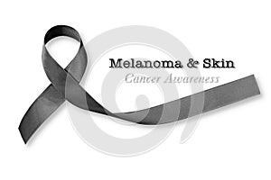 Melanoma and skin cancer, black awareness ribbon isolated on white background, clipping path photo
