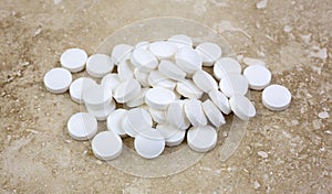 Melatonin tablets on marble tile