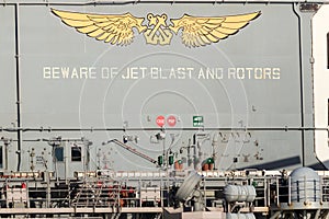 Beware of jet blast and rotors sign on the deck of the USS Bonhomme Richard.