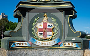 Melbourne city coat of arms and Latin motto Vires Acquirit Eundo on Princes bridge in Victoria Australia