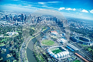 MELBOURNE - SEPTEMBER 8, 2018: Aerial view of city skyline and stadiums from helicopter. Melbourne attracts 15 million people