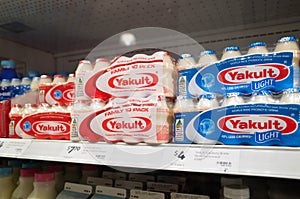 Some bottles of Yakult probiotic milk on the supermarket shelf. It`s a sweetened  beverage fermented with the lactobacillus paraca