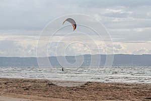 Melbystrand Sweden A kitesurfer practise his surfing skills close to beach with sand dunes