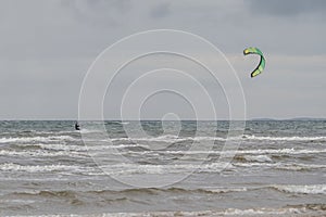 Melbystrand Sweden A kitesurfer practise his surfing skills close to beach with sand dunes