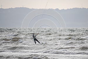 Melbystrand Sweden A kitesurfer practise his surfing skills close to beach with sand dunes