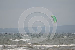 Melbystrand Sweden A kitesurfer practise his surfing skills close to beach with sand dunes