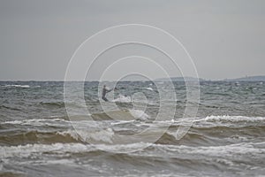 Melbystrand Sweden A kitesurfer practise his surfing skills close to beach with sand dunes