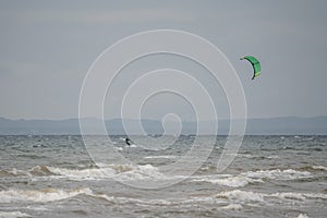 Melbystrand Sweden A kitesurfer practise his surfing skills close to beach with sand dunes