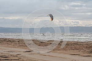 Melbystrand Sweden A kitesurfer practise his surfing skills close to beach with sand dunes