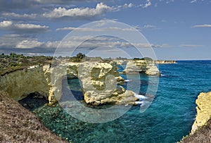 Melendugno, province of Lecce, Puglia, Italy. August 2021. The stacks of Sant`Andrea are a point of naturalistic attraction: larg