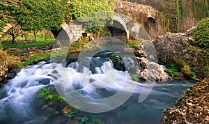 Melide, Spain - The Medieval Bridge Puente San Xoan across the River Furelos, outside Melide in Galicia, on the Camino de Santiago photo