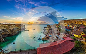 Mellieha, Malta - Skyline view of the beautiful Popeye Village at Anchor Bay at sunset