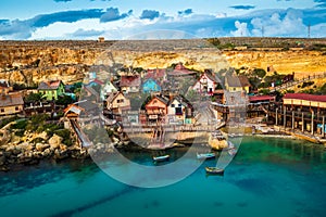 Mellieha, Malta - Sunset at the famous Popeye Village at Anchor Bay with blue sky