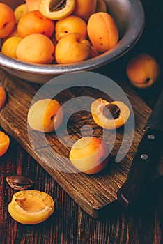 Mellow apricots with knife over cutting board