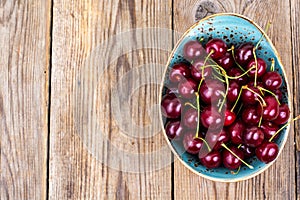 Mellow sweet cherry in bowl on wooden table