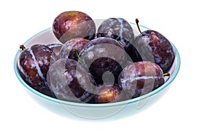 Mellow sweet plum in plate on white background