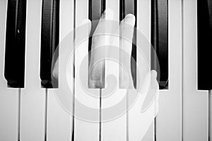 Melody. Concept photo. Double exposure. Black and white. Hand and piano.