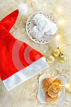 Melomakarona and kourabiedes ,traditional greek Christmas sweets on sheepskin carpet