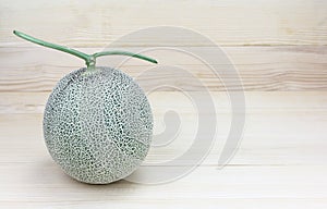 Melon or cantaloupe melon with seeds on wood background