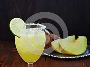 Melon coconut mocktail with lime and ice in glass