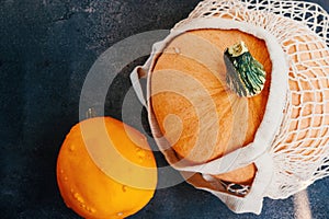 melon in a cotton net. Mesh shopping bag with vegetables Autumn pumpkin harvest. Ripe juicy melon in a cotton mesh bag