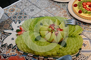 Melon cut with strawberry and kiwi topping