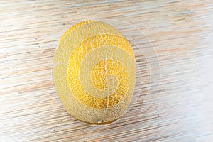 Melon fresh whole fruit yellow on light background